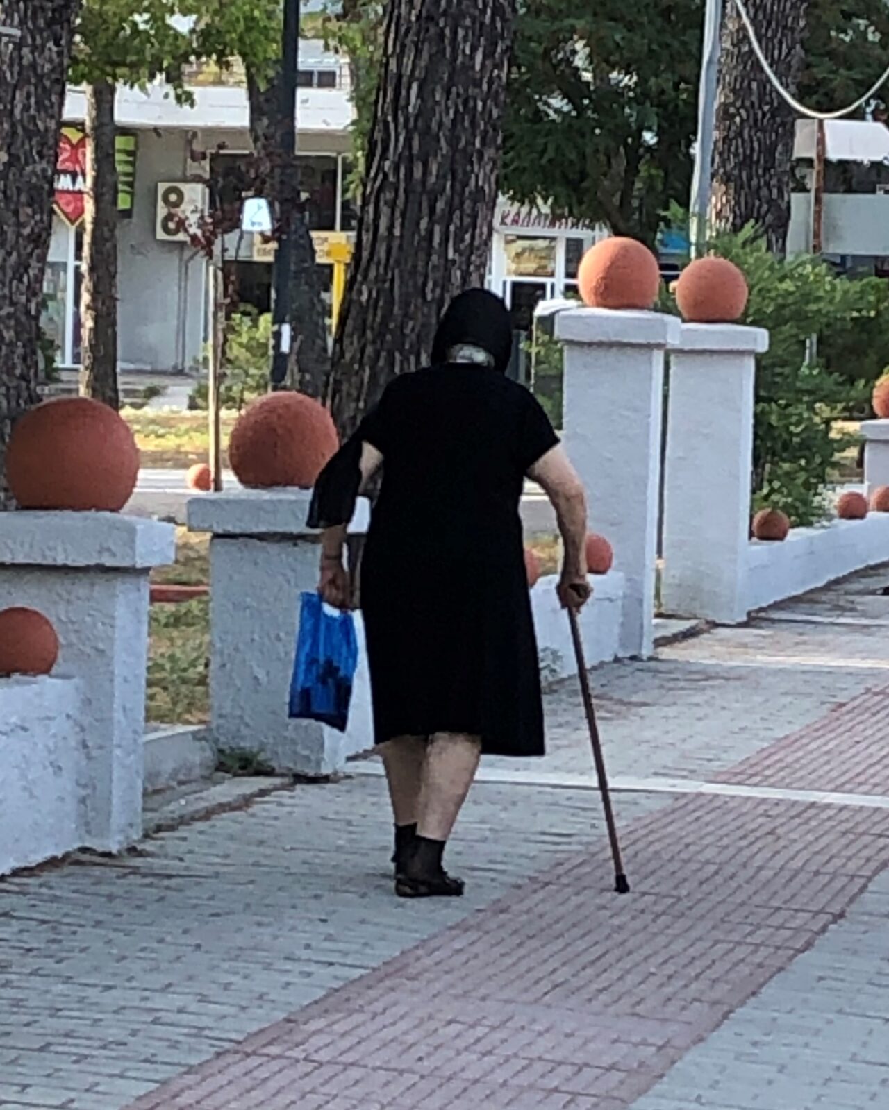 Elderly Woman with Groceries in Greece