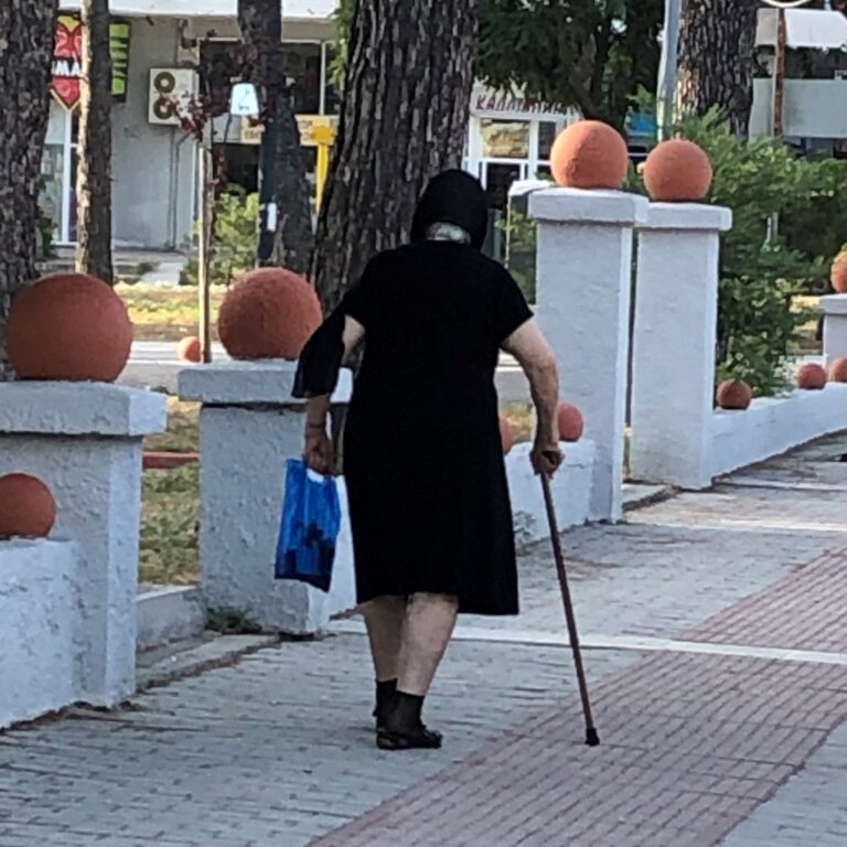 Elderly Woman with Groceries in Greece